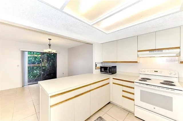 a kitchen with a stove a sink and a refrigerator