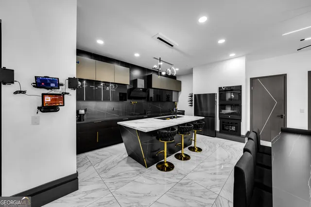 a kitchen with stainless steel appliances granite countertop a stove refrigerator and a microwave