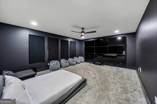a living room with stainless steel appliances furniture a rug and kitchen view