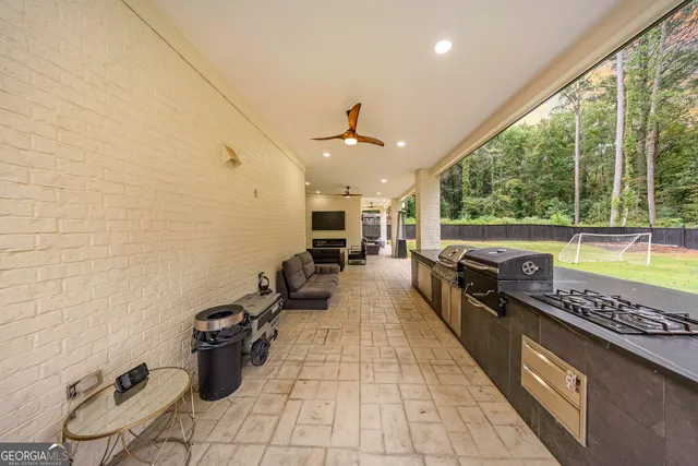 a view of a house with backyard and sitting area