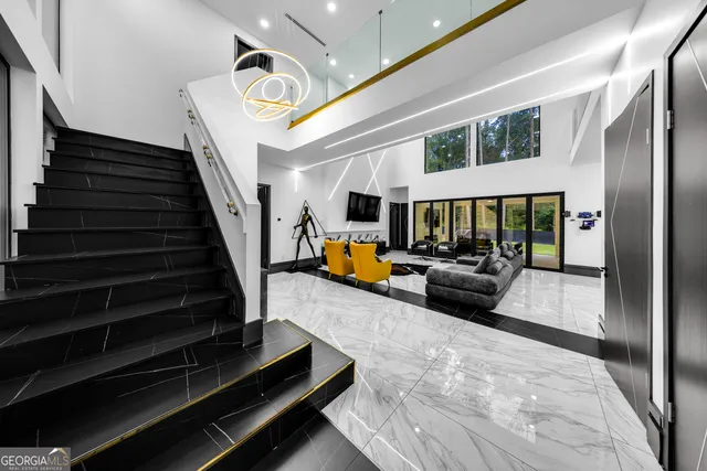 a view of a livingroom with furniture and a floor to ceiling window