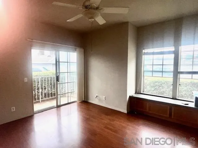 13802 Midland Road Poway, CA 92064 - Photo 4 of 12 an empty room with wooden floor and windows