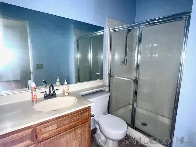 13802 Midland Road Poway, CA 92064 - Photo 7 of 12 a bathroom with a granite countertop sink toilet and shower