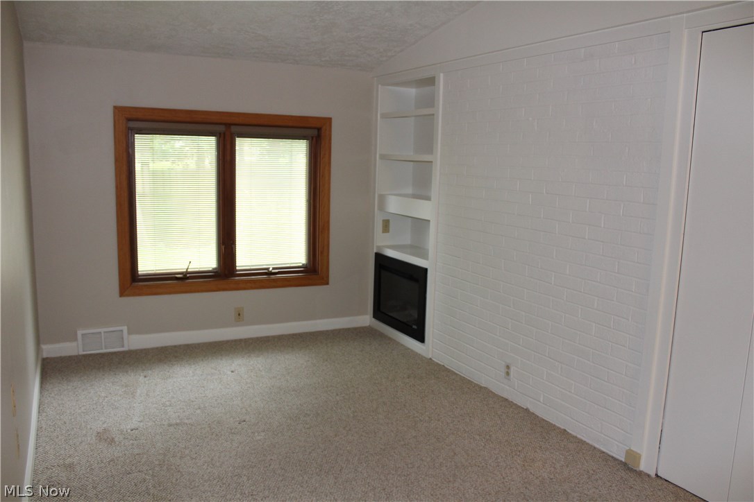 5807 East Sprague Road Independence, OH 44131 - Photo 12 of 33 Breezeway was finished to add more living space, would make a great sitting / study. Electric fireplace in the corner