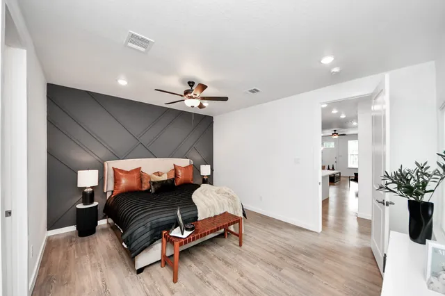 a bedroom with furniture and wooden floor