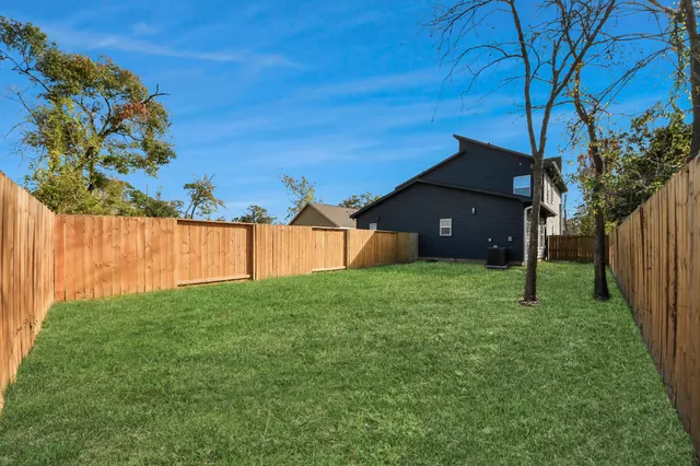 an aerial view of residential houses with outdoor space and street view