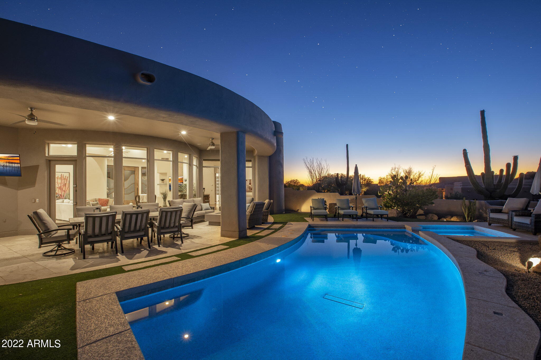 a view of a swimming pool with outdoor seating