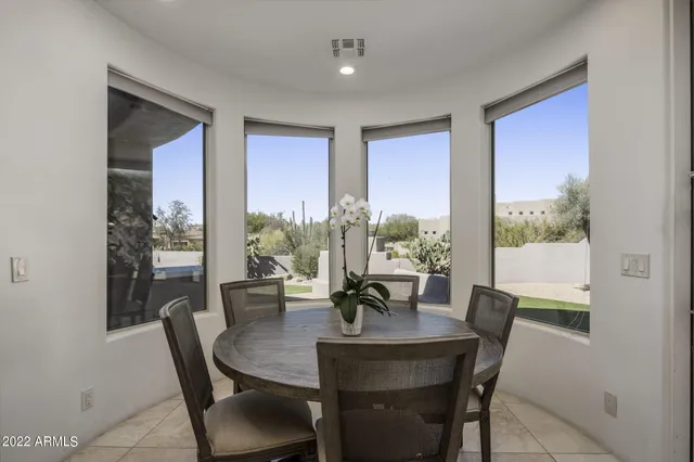a living room with furniture a rug and a large window