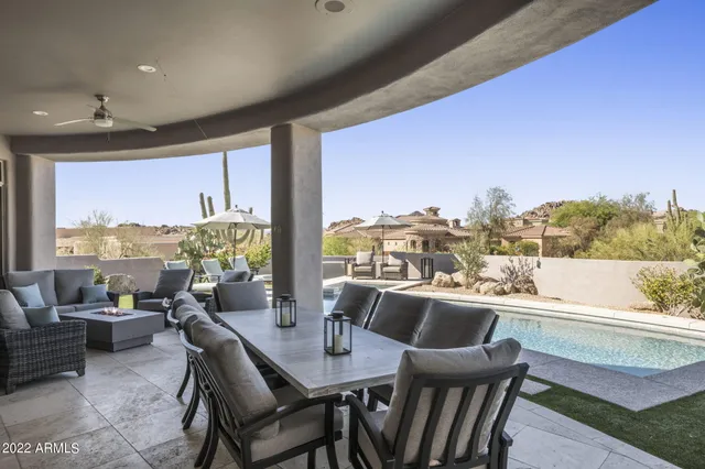 a living room with furniture a rug and a floor to ceiling window