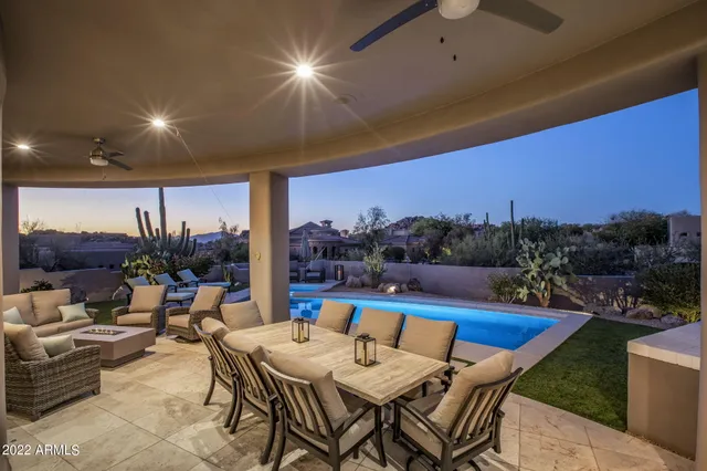 a view of a patio with couches under an umbrella