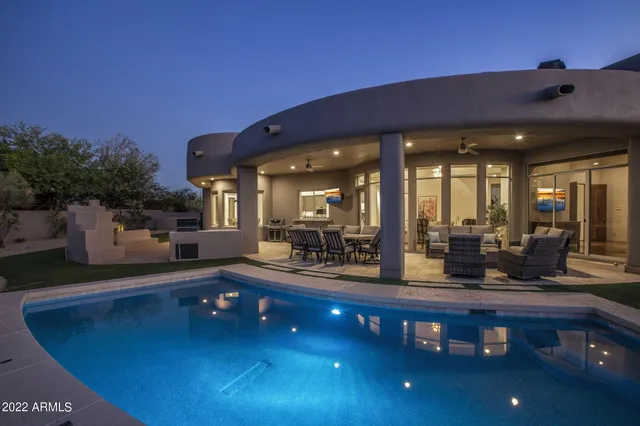 a roof deck with outdoor seating and city view