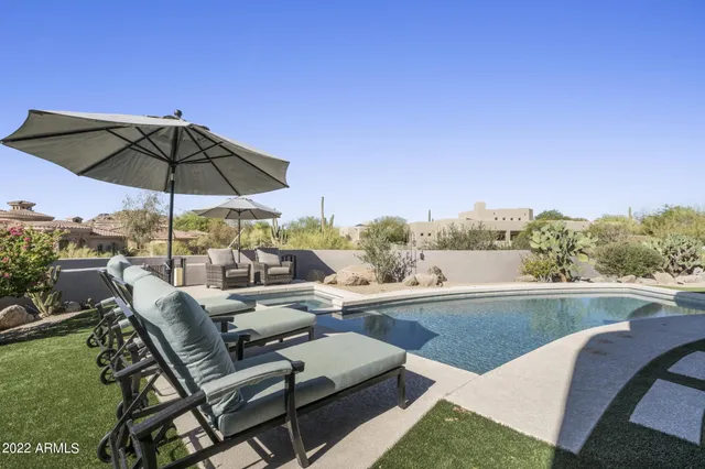 a view of swimming pool with outdoor seating