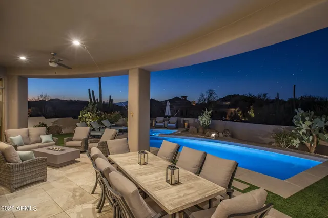 a view of a swimming pool with lawn chairs