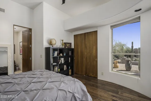 a view of a patio with couches table and chairs with wooden floor