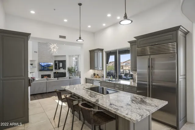 a kitchen with granite countertop a sink a counter top space and cabinets