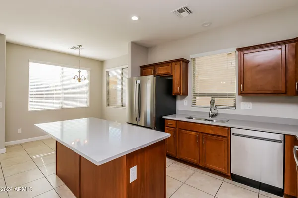 a view of a kitchen with a stove wooden floor and a kitchen space