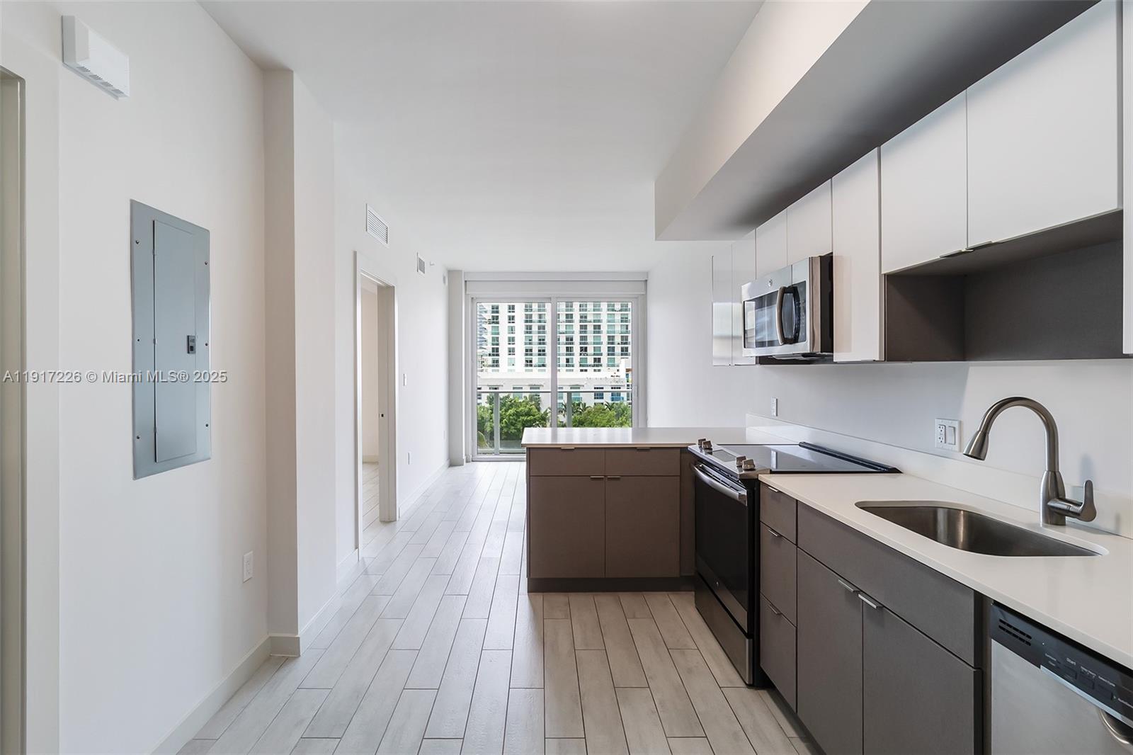 321 Northeast 26th Street, Unit 614 Miami, FL 33137 - Photo 11 of 22 a kitchen with a sink and a stove top oven