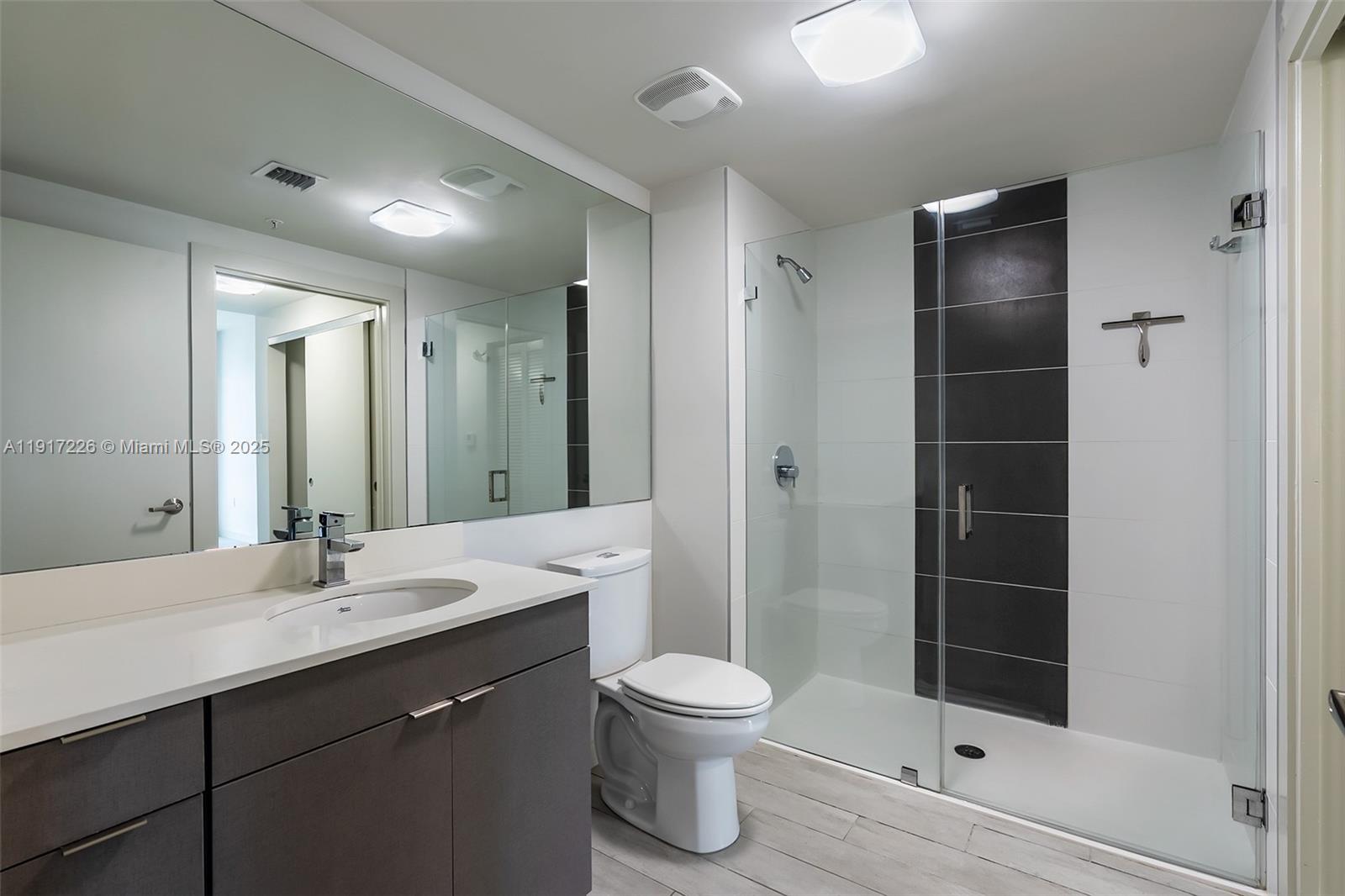 321 Northeast 26th Street, Unit 614 Miami, FL 33137 - Photo 9 of 22 a bathroom with a sink a toilet and shower