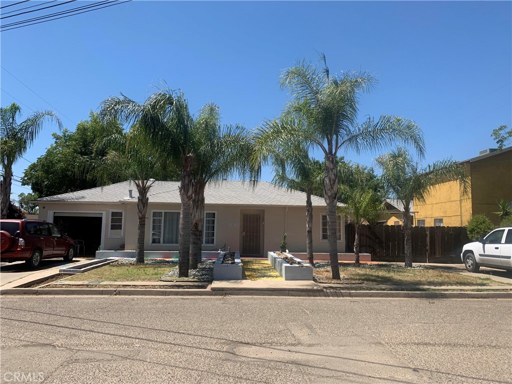 890 Barney Street Merced, CA 95340 - Photo 1 of 1 a view of a house with a swimming pool and a lawn chairs with plants