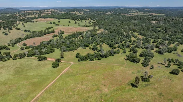 an aerial view of a houses with a yard