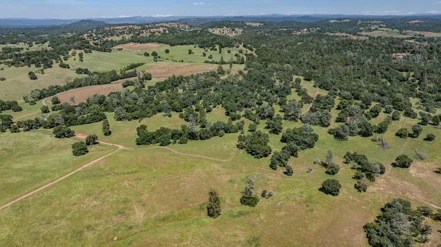 an aerial view of a houses with a yard