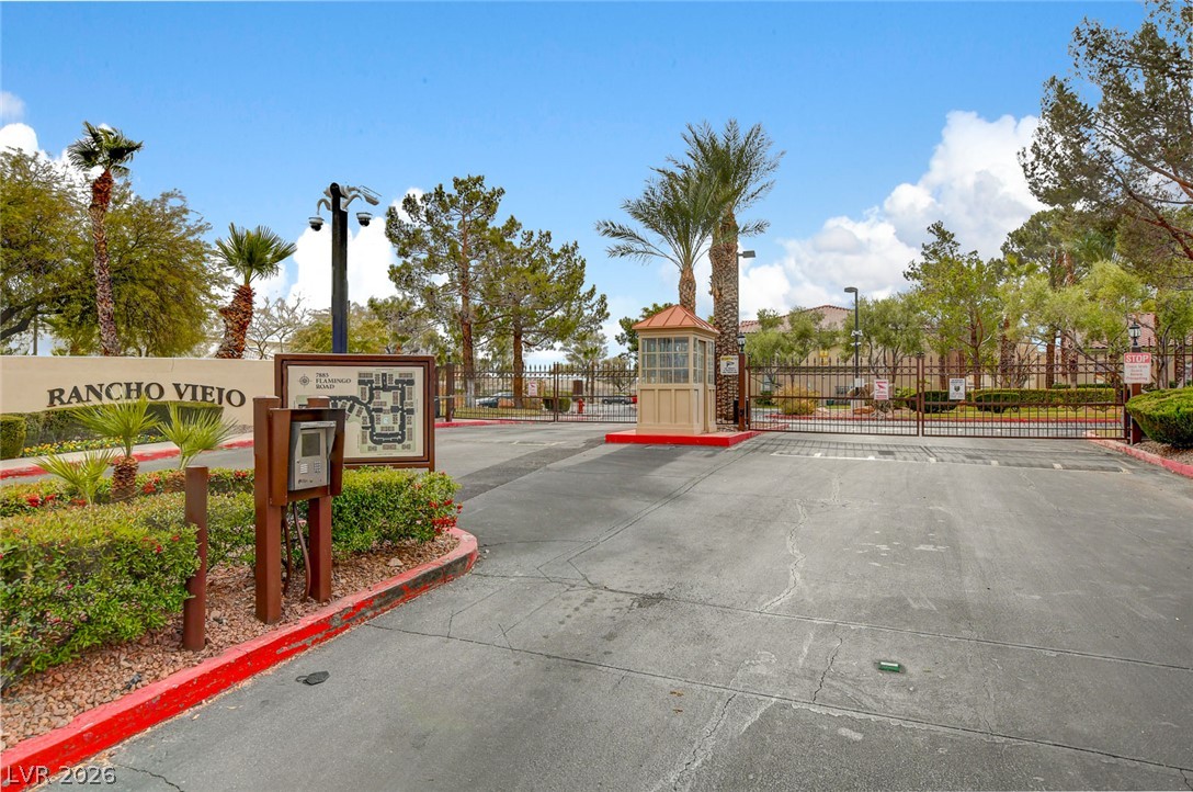 7885 West Flamingo Road, Unit 1050 Las Vegas, NV 89147 - Photo 35 of 62 Secure community entrance with an inviting gated entry and lush landscaping.