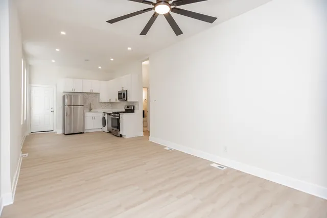 a view of a kitchen with a sink and cabinets