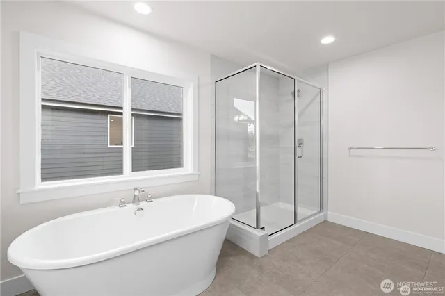 a bathroom with a bathtub and a shower