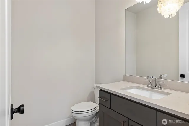 a bathroom with a sink a toilet and window
