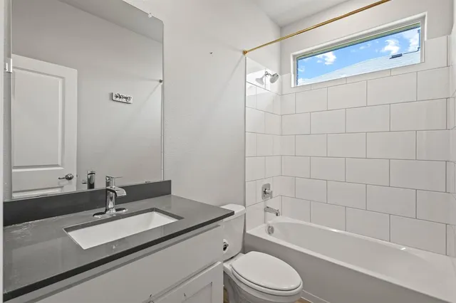 a bathroom with a sink a toilet and bathtub