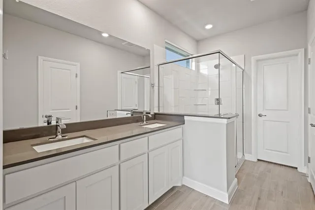 a bathroom with double sink and a mirror