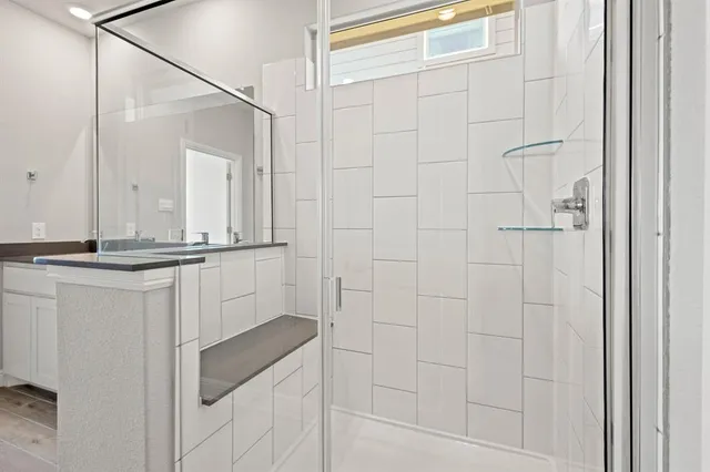 a bathroom with a shower and vanity