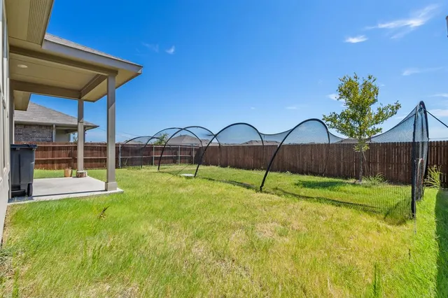 a view of a backyard with table and chairs