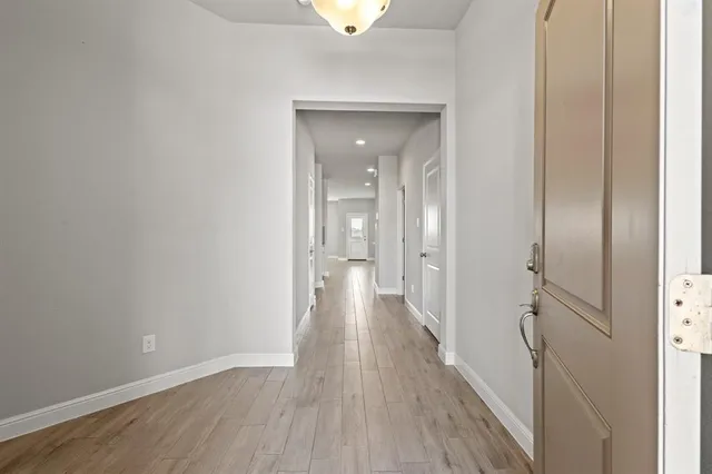 a view of a hallway with wooden floor