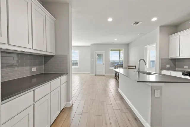a kitchen with stainless steel appliances granite countertop a sink and cabinets