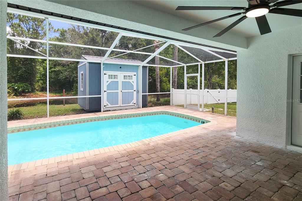 7027 Frascati Loop Wesley Chapel, FL 33544 - Photo 23 of 28 a view of an empty room with wooden floor and a yard