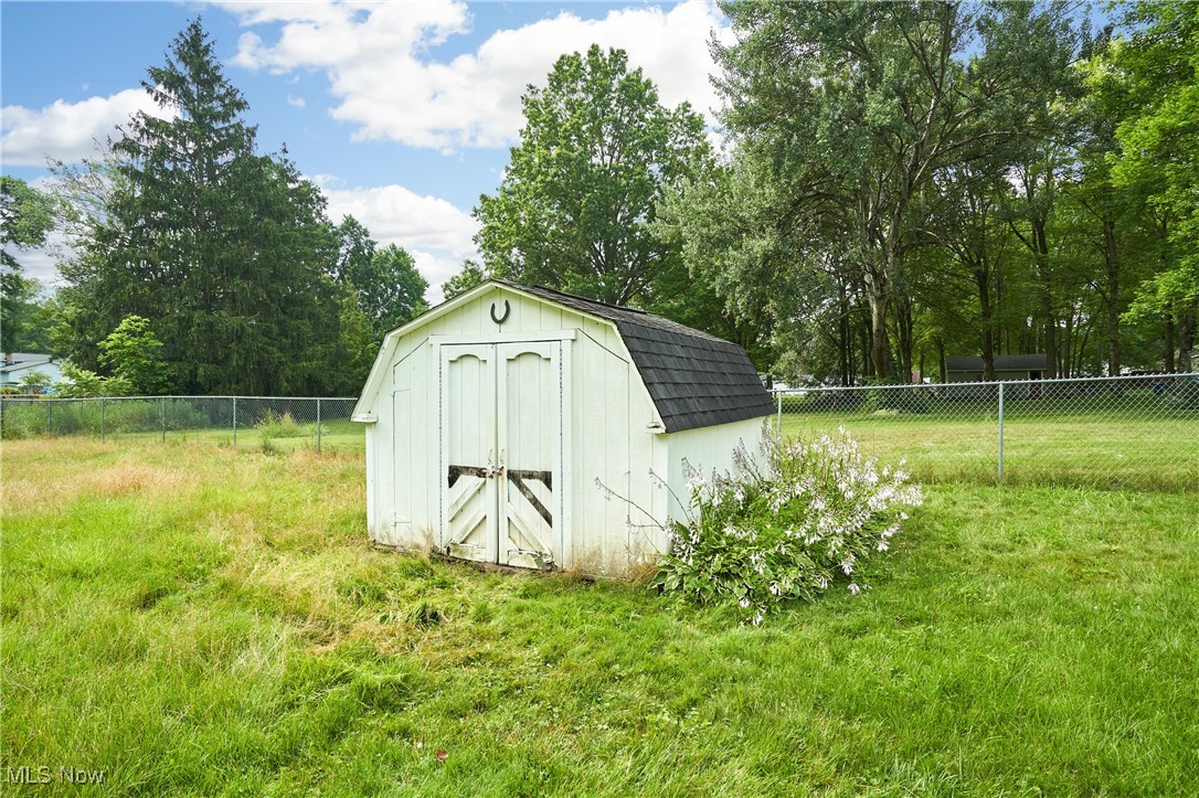 1433 Raleigh Boulevard Akron, OH 44321 - Photo 23 of 25 View of shed with a fenced backyard and view of wooded area