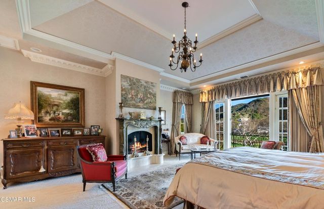 a bed room with furniture and a fireplace