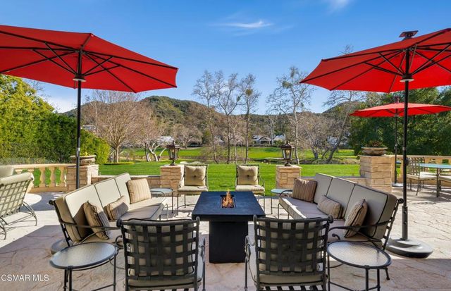 a view of an outdoor sitting area with furniture and umbrella