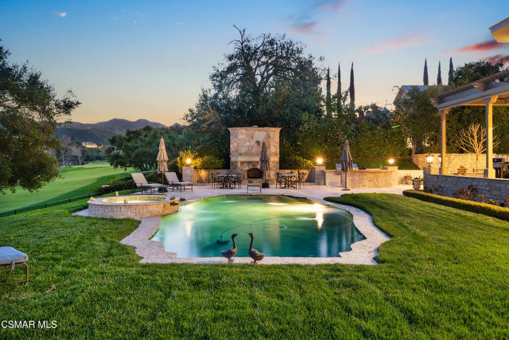 240 West Stafford Road Thousand Oaks, CA 91361 - Photo 17 of 26 a view of a swimming pool with a bench and trees around