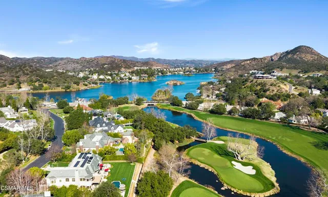 an aerial view of a house with a lake view