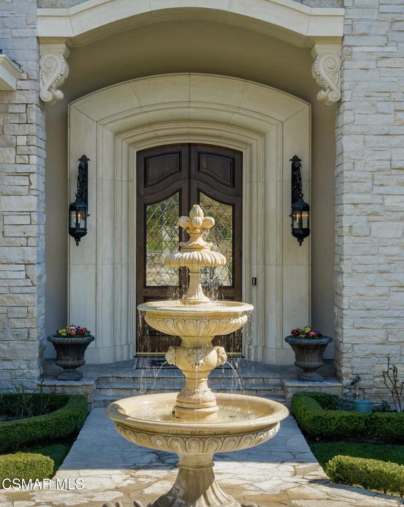 240 West Stafford Road Thousand Oaks, CA 91361 - Photo 3 of 26 a front view of a house with fountain