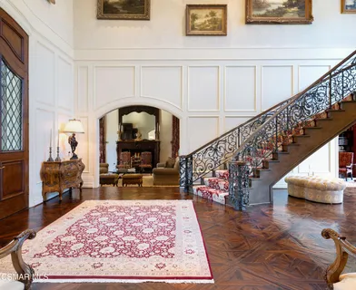 a living room with stairs and a table