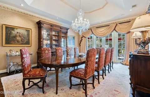 a view of a dining room with furniture and chandelier