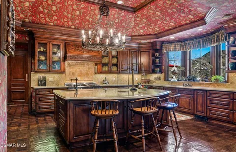 a kitchen with a counter space a sink and cabinets