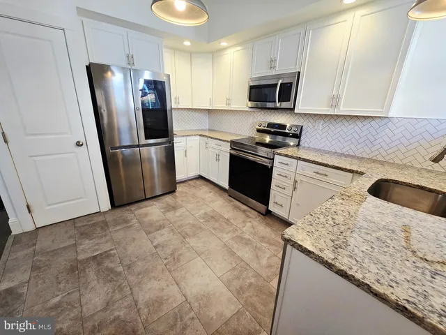 a kitchen with a refrigerator sink and microwave