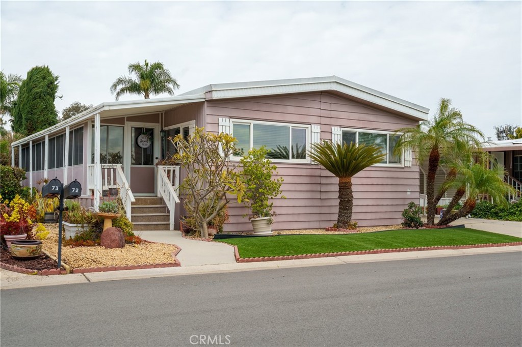 4000 Pierce Street, Unit 72 Riverside, CA 92505 - Photo 1 of 20 a front view of a house with a yard and potted plants