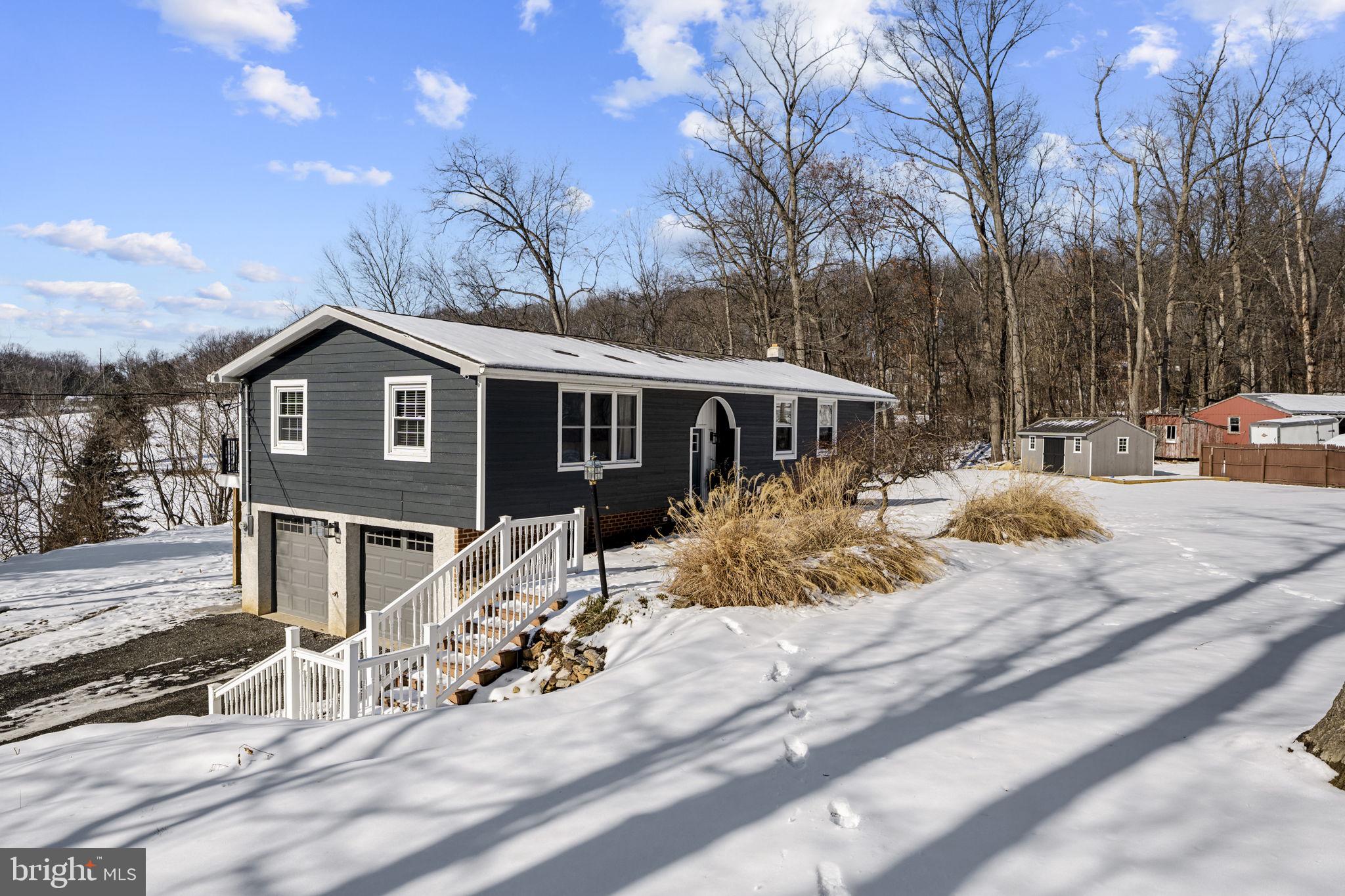 a view of a house with snow on the road