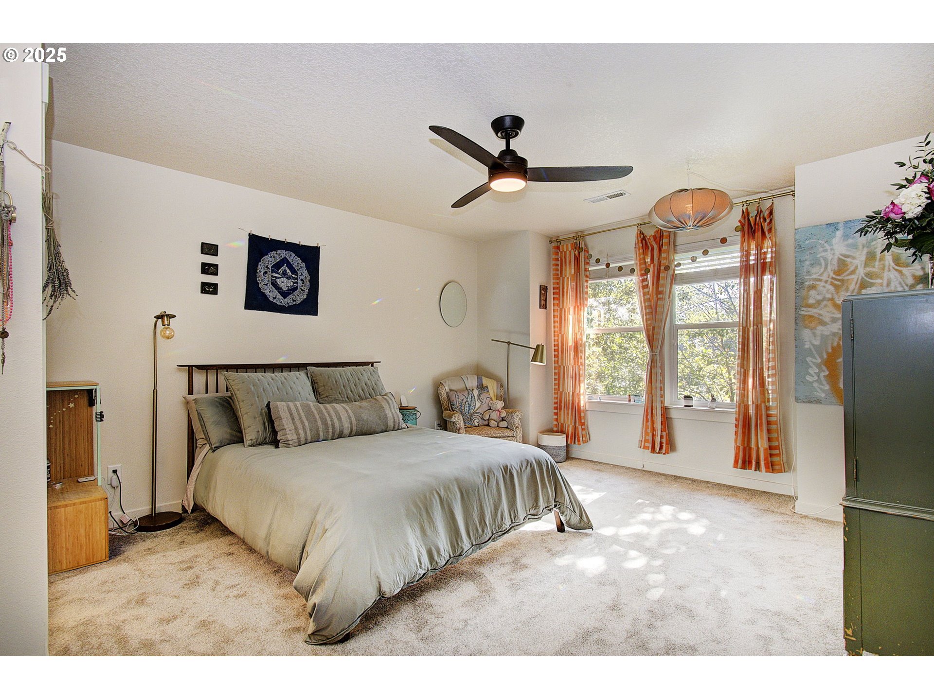 7327 South 13th Street Ridgefield, WA 98642 - Photo 18 of 34 a bedroom with a large bed and a chandelier