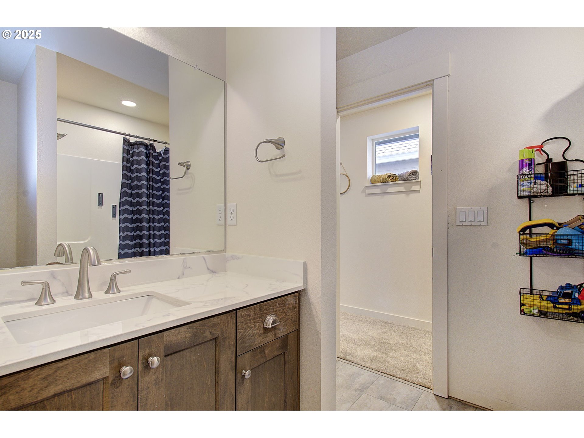 7327 South 13th Street Ridgefield, WA 98642 - Photo 27 of 34 a bathroom with a sink a toilet and a mirror